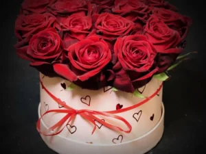 Flowerbox Love klein, een box met rode rozen gestoken in een blok oase. Deze rozen zitten in een zachtroze box met hartjes erop.
